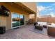 Inviting outdoor patio with comfortable seating and a mounted television, great for relaxing and entertaining guests at 4580 E Gagarinite Ln, San Tan Valley, AZ 85143