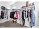 Well-organized walk-in closet with ample hanging space and shelving for shoes and accessories at 4580 E Gagarinite Ln, San Tan Valley, AZ 85143