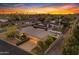 Aerial view showcasing the home with a private pool and lush backyard at sunset at 4596 E Calle Ventura --, Phoenix, AZ 85018