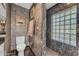 This bathroom features a toilet, towel rack, and a glass block window providing natural light at 4596 E Calle Ventura --, Phoenix, AZ 85018