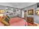 Bedroom with built-in shelves, ceiling fan, terracotta floors and vintage furniture at 4596 E Calle Ventura --, Phoenix, AZ 85018