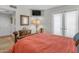 Charming bedroom featuring terra cotta floors, metal bed frame, and a wall-mounted television at 4596 E Calle Ventura --, Phoenix, AZ 85018
