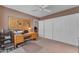 Bedroom with a ceiling fan, a desk, and a closet with white doors at 4596 E Calle Ventura --, Phoenix, AZ 85018