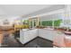 Bright open-concept kitchen with a granite countertop island and white cabinets at 4596 E Calle Ventura --, Phoenix, AZ 85018