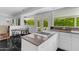 Modern kitchen with island cooktop, marble countertops, and large windows at 4596 E Calle Ventura --, Phoenix, AZ 85018