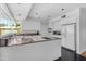 Bright kitchen featuring white cabinetry, modern appliances, and an island cooktop at 4596 E Calle Ventura --, Phoenix, AZ 85018