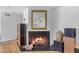 Living room features a fireplace with black marble surround and mantle and a decorative mirror above it at 4596 E Calle Ventura --, Phoenix, AZ 85018