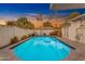 Sparkling blue swimming pool surrounded by lush landscaping, perfect for summer relaxation at 4596 E Calle Ventura --, Phoenix, AZ 85018