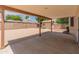 Spacious back patio with a covered area, leading to a gravel backyard and detached shed at 4746 W Taro Dr, Glendale, AZ 85308