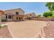 View of the property's backyard showcasing low maintenance landscaping, block fence, and covered patio at 4746 W Taro Dr, Glendale, AZ 85308