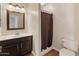 Bathroom featuring a vanity with dark wood cabinets and a shower with a dark shower curtain at 4746 W Taro Dr, Glendale, AZ 85308