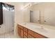 Bathroom features a double sink vanity, a large mirror and a bathtub/shower combo with white tile at 4746 W Taro Dr, Glendale, AZ 85308