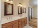 Bathroom with double vanity, framed mirrors, and modern lighting fixtures at 4746 W Taro Dr, Glendale, AZ 85308