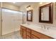Bathroom featuring a double vanity, framed mirrors, and a large glass-enclosed shower at 4746 W Taro Dr, Glendale, AZ 85308