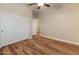 Bedroom with wood flooring, a ceiling fan, and a sliding-door closet for ample storage solutions at 4746 W Taro Dr, Glendale, AZ 85308