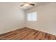 Bright bedroom features sleek wood flooring, a ceiling fan, and a window offering plenty of natural light at 4746 W Taro Dr, Glendale, AZ 85308