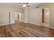 Bedroom with wood-look floors, neutral walls, a ceiling fan, and two doorways at 4746 W Taro Dr, Glendale, AZ 85308