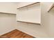 Walk-in closet with wood-look floors and built-in shelving at 4746 W Taro Dr, Glendale, AZ 85308