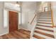 Inviting foyer with wood floors, a decorative front door, and staircase at 4746 W Taro Dr, Glendale, AZ 85308
