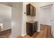 Hallway featuring dark cabinetry with granite counters, wood floors, and views to the upstairs hallway at 4746 W Taro Dr, Glendale, AZ 85308