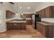 Well-lit kitchen featuring an island, stainless steel appliances, granite counters, and abundant cabinet space at 4746 W Taro Dr, Glendale, AZ 85308