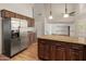 Spacious kitchen featuring stainless steel appliances, an island with granite countertops, and wood cabinets at 4746 W Taro Dr, Glendale, AZ 85308