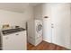Convenient laundry room featuring modern, white washer and dryer units and a door leading to other areas at 4746 W Taro Dr, Glendale, AZ 85308