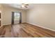 Living room with wood-look floors, neutral walls, a ceiling fan, and a window with mountain views at 4746 W Taro Dr, Glendale, AZ 85308