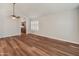 Large living room with hardwood flooring leading to a kitchen with granite countertops at 4746 W Taro Dr, Glendale, AZ 85308