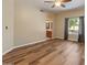 Living room with wood-look floors, neutral walls, a ceiling fan, and a view into the bathroom at 4746 W Taro Dr, Glendale, AZ 85308
