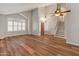 Open living room featuring wood floors, shutters, and a vaulted ceiling at 4746 W Taro Dr, Glendale, AZ 85308