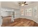 Open living space featuring an upper level with hardwood floors and a ceiling fan at 4746 W Taro Dr, Glendale, AZ 85308