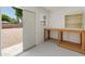 Bright workshop featuring a workbench, shelving, and exterior access to the large, gravel-covered backyard at 4746 W Taro Dr, Glendale, AZ 85308