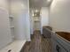 Bathroom with gray cabinets and a walk-in shower featuring modern fixtures and design at 47692 W Moeller Rd, Maricopa, AZ 85139