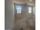 Unfinished bedroom showcasing natural light from two windows and blank canvas walls at 47692 W Moeller Rd, Maricopa, AZ 85139
