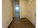 Hallway features tile flooring, white walls and doors, and recessed lighting at 47692 W Moeller Rd, Maricopa, AZ 85139