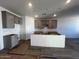 Kitchen with gray cabinets and a center island, ready for countertops and appliances at 47692 W Moeller Rd, Maricopa, AZ 85139