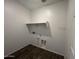 Functional laundry room with shelf and utility hookups at 47692 W Moeller Rd, Maricopa, AZ 85139