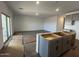 Open-concept living room area with sliding glass doors, wood style floors, and kitchen view at 47692 W Moeller Rd, Maricopa, AZ 85139