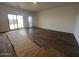 Spacious living room with wood style floors and sliding glass doors leading to the outdoor area at 47692 W Moeller Rd, Maricopa, AZ 85139
