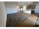 Open floor plan with hardwood style flooring, showcasing the kitchen area from the living room at 47692 W Moeller Rd, Maricopa, AZ 85139