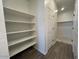 Spacious pantry with built-in shelving, tile floors, and a convenient access door at 47692 W Moeller Rd, Maricopa, AZ 85139