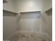Unfinished walk-in storage room with built in shelves at 47692 W Moeller Rd, Maricopa, AZ 85139