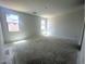 An empty bedroom with two windows providing natural light ready for new flooring and personalization at 47719 W Moeller Rd, Maricopa, AZ 85139
