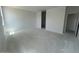 Large open living room with fresh paint, awaiting new flooring, and ready for personal touches at 47719 W Moeller Rd, Maricopa, AZ 85139