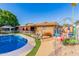 Inviting backyard featuring a sparkling pool, cozy seating area, and mature landscaping at 4804 S Elm St, Tempe, AZ 85282