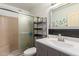 Updated bathroom featuring a sleek vanity, stylish mirror, and a glass door shower at 4804 S Elm St, Tempe, AZ 85282