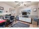 A bedroom furnished with a desk, cabinet, and a view from a large window allowing plenty of natural light at 4804 S Elm St, Tempe, AZ 85282