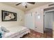 A bedroom with terra cotta floors and a bed, and a double closet and large picture on the wall at 4804 S Elm St, Tempe, AZ 85282