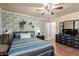 Cozy bedroom featuring stylish wallpaper, neutral paint, and two matching nightstands at 4804 S Elm St, Tempe, AZ 85282